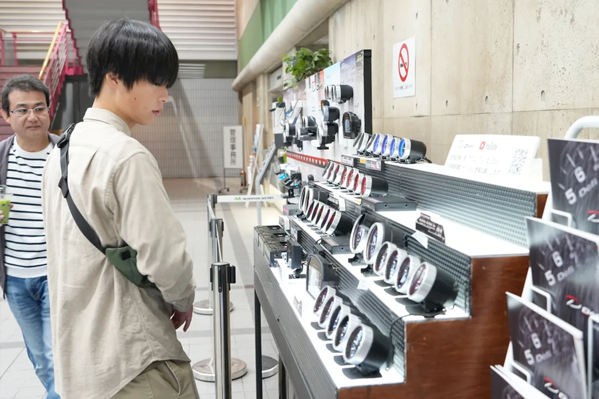 展示製品を見つめ、従業員の仕事ぶりを感じ取る家族