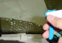 Spray a mixture of water and mild detergent